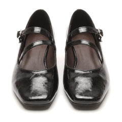 Annelise-Estelle women's black patent cross-strap Mary Jane block heels, pair on white